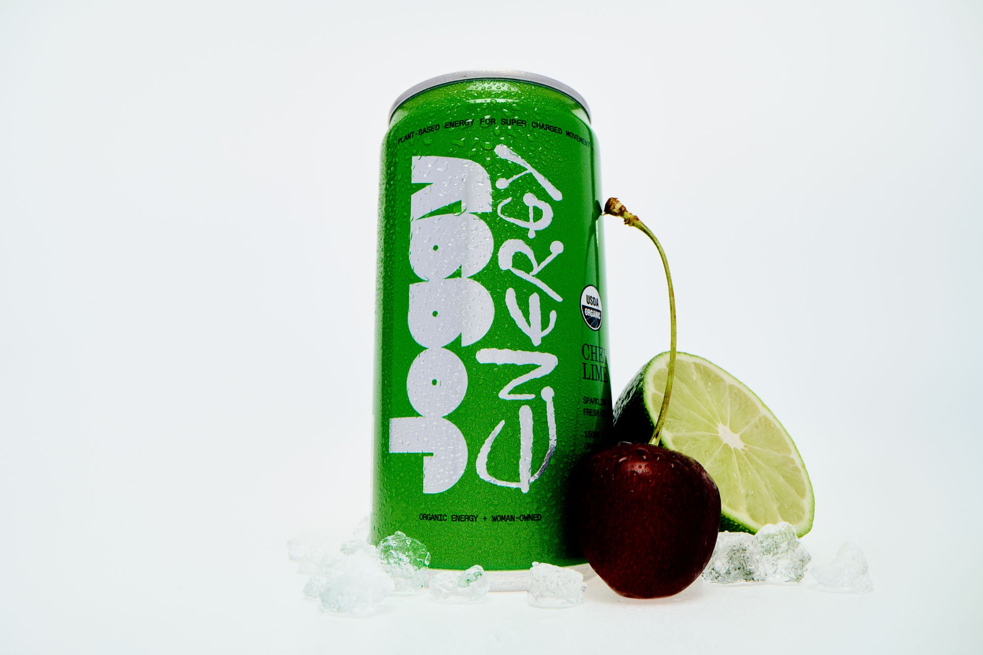 Green energy drink can with a cherry and lime on a white background