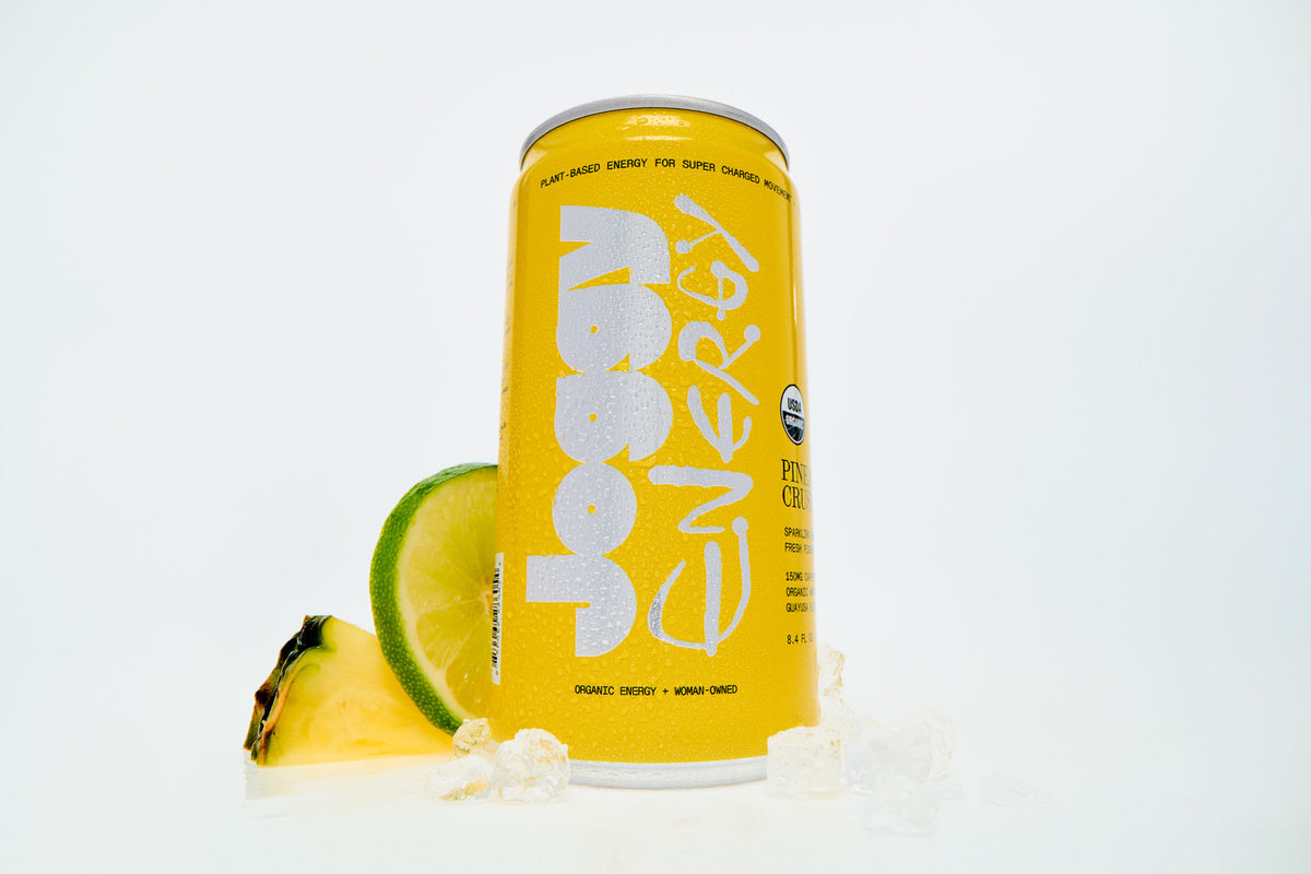 Yellow energy drink can with lime slices on a white background