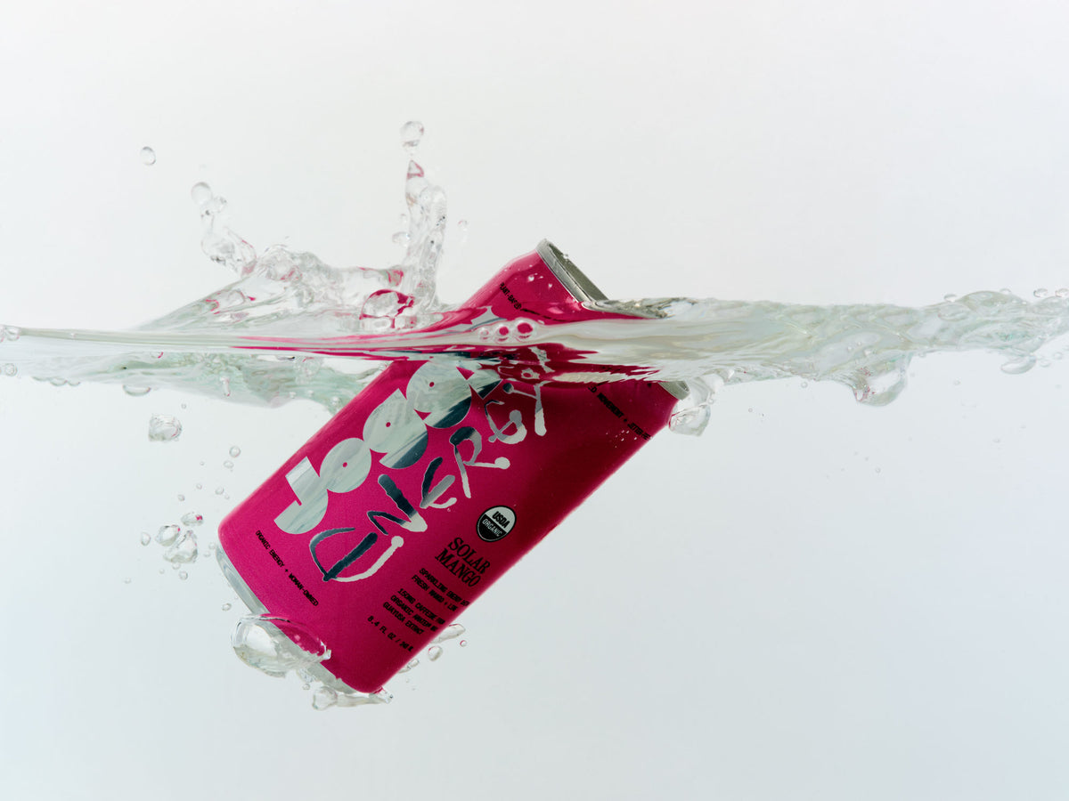 Solar Mango Joggy splashing into water on a white background
