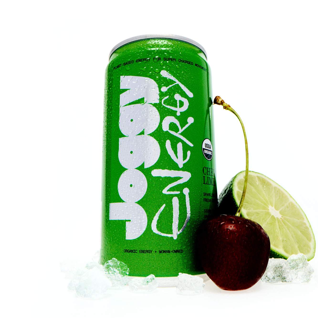 Green energy drink can with a cherry and lime wedge on a white background