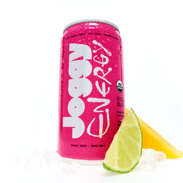Pink energy drink can with lemon and lime slices on a white background